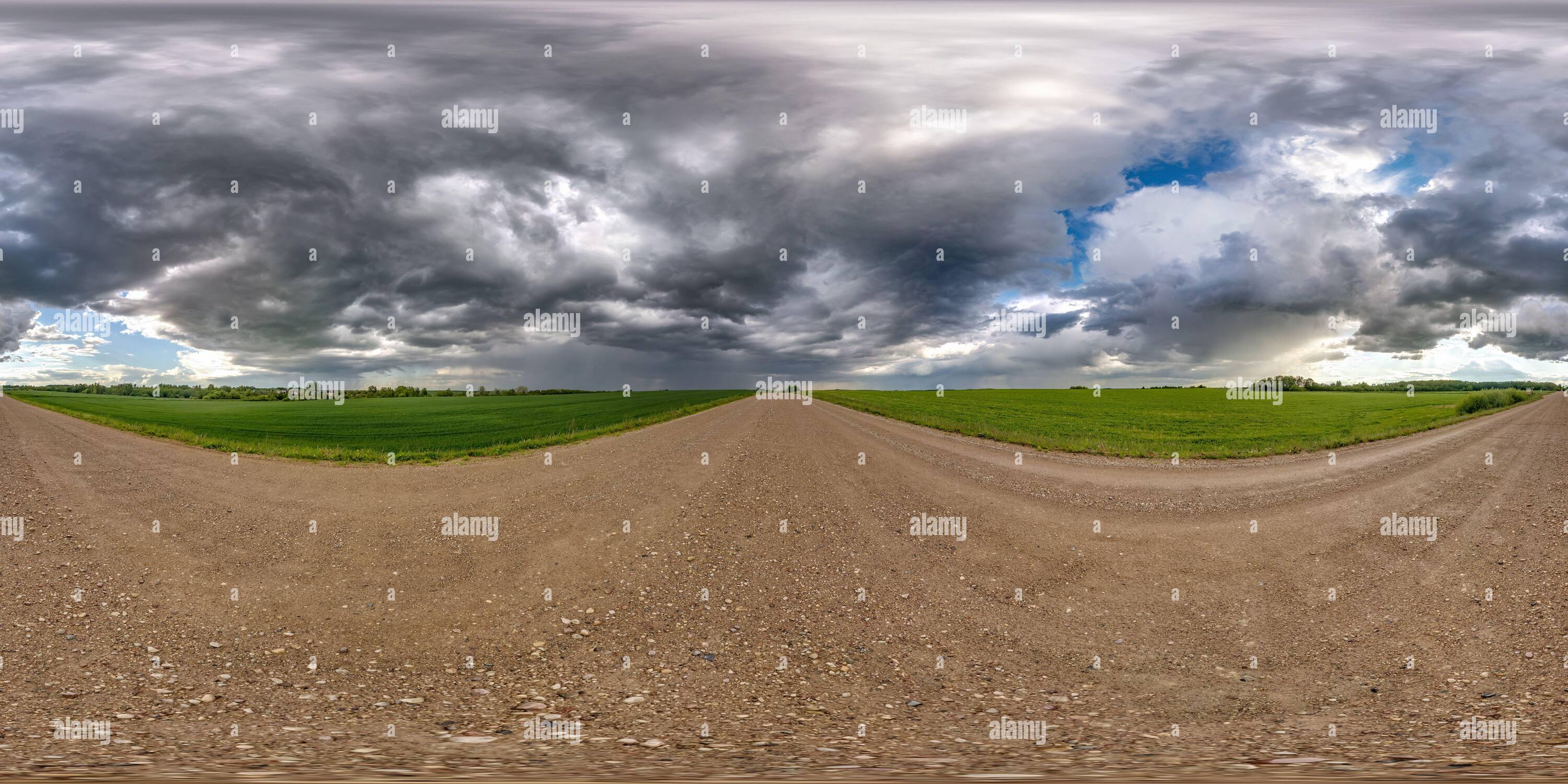 360 degree panoramic view of full seamless spherical hdri panorama 360 degrees angle view on wet gravel road among fields in spring day with storm clouds after rain in equirectang