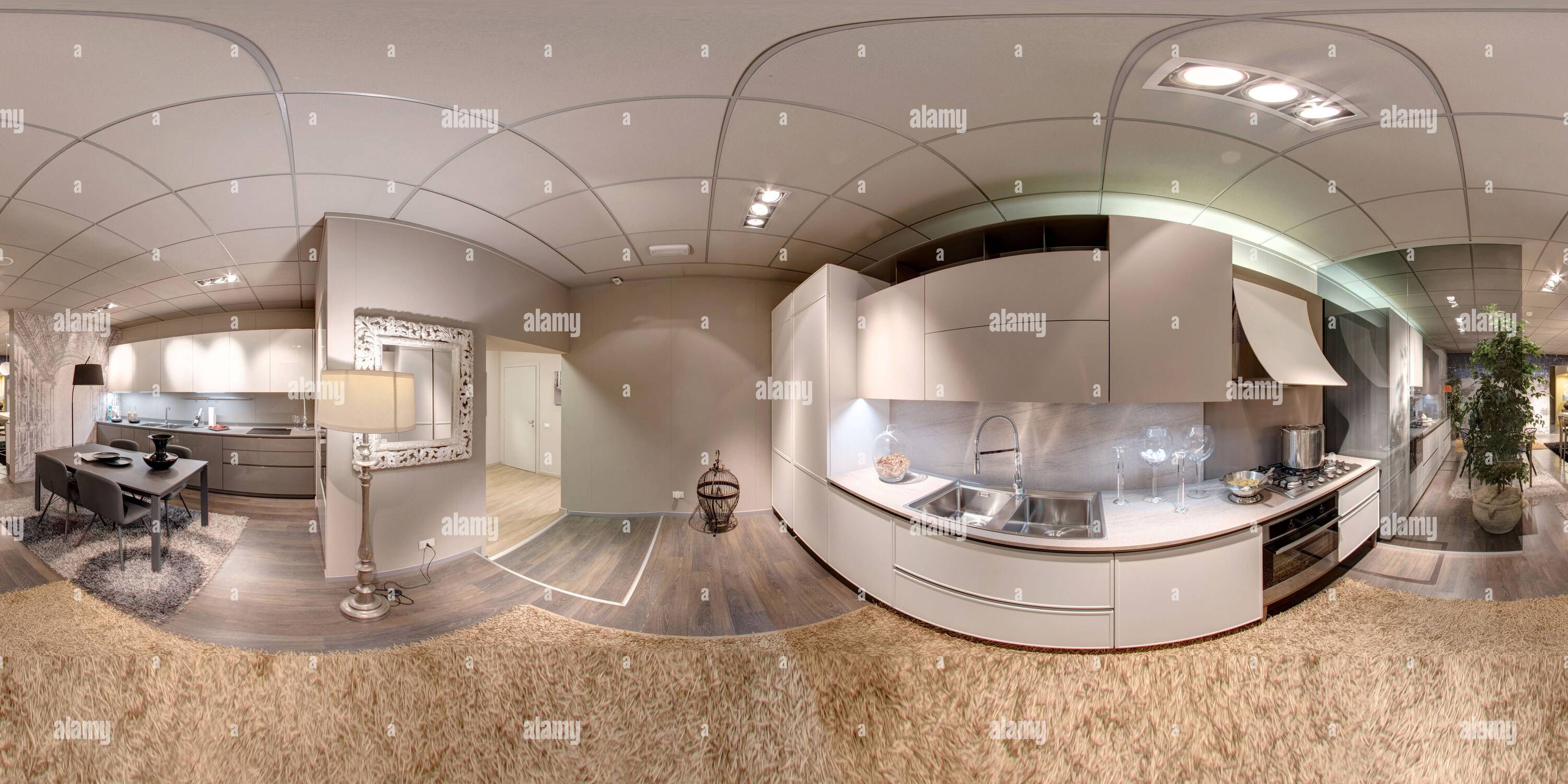 360 degree panoramic view of 360 degree panorama of a kitchen showroom with modern built-in appliances and white cabinets on display in a furniture store