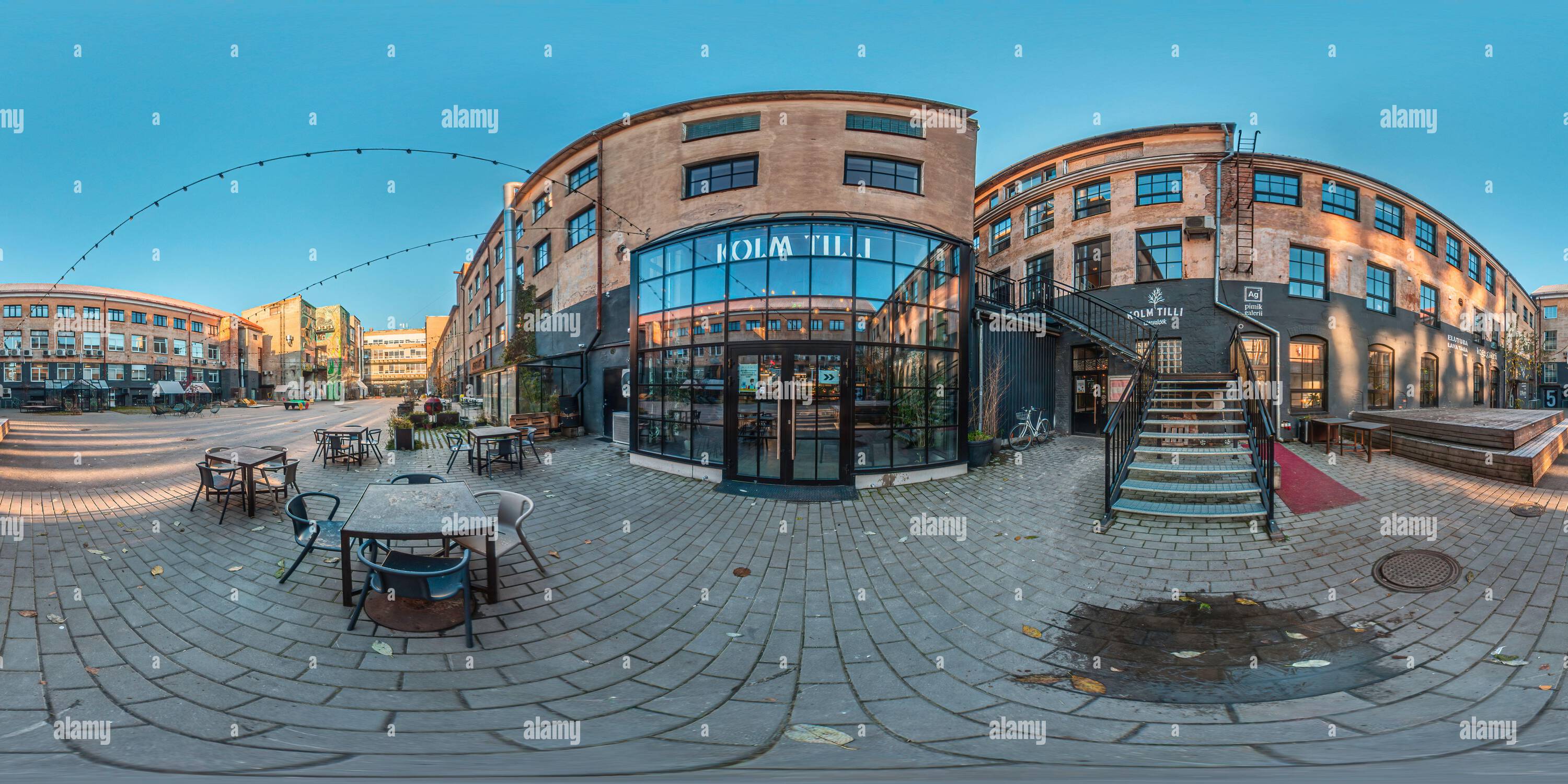 360 degree panoramic view of In front of glass windows of a posh restaurant in a historic culture factory area