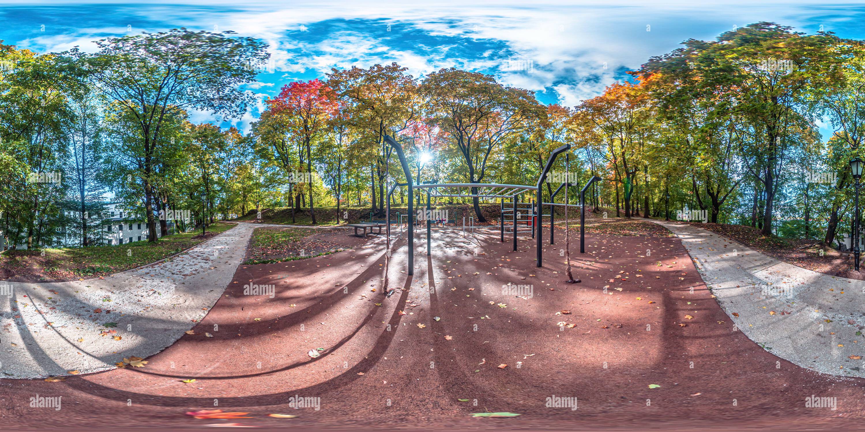 360 degree panoramic view of 360 view of an autumn park with colorful leaves and a playground