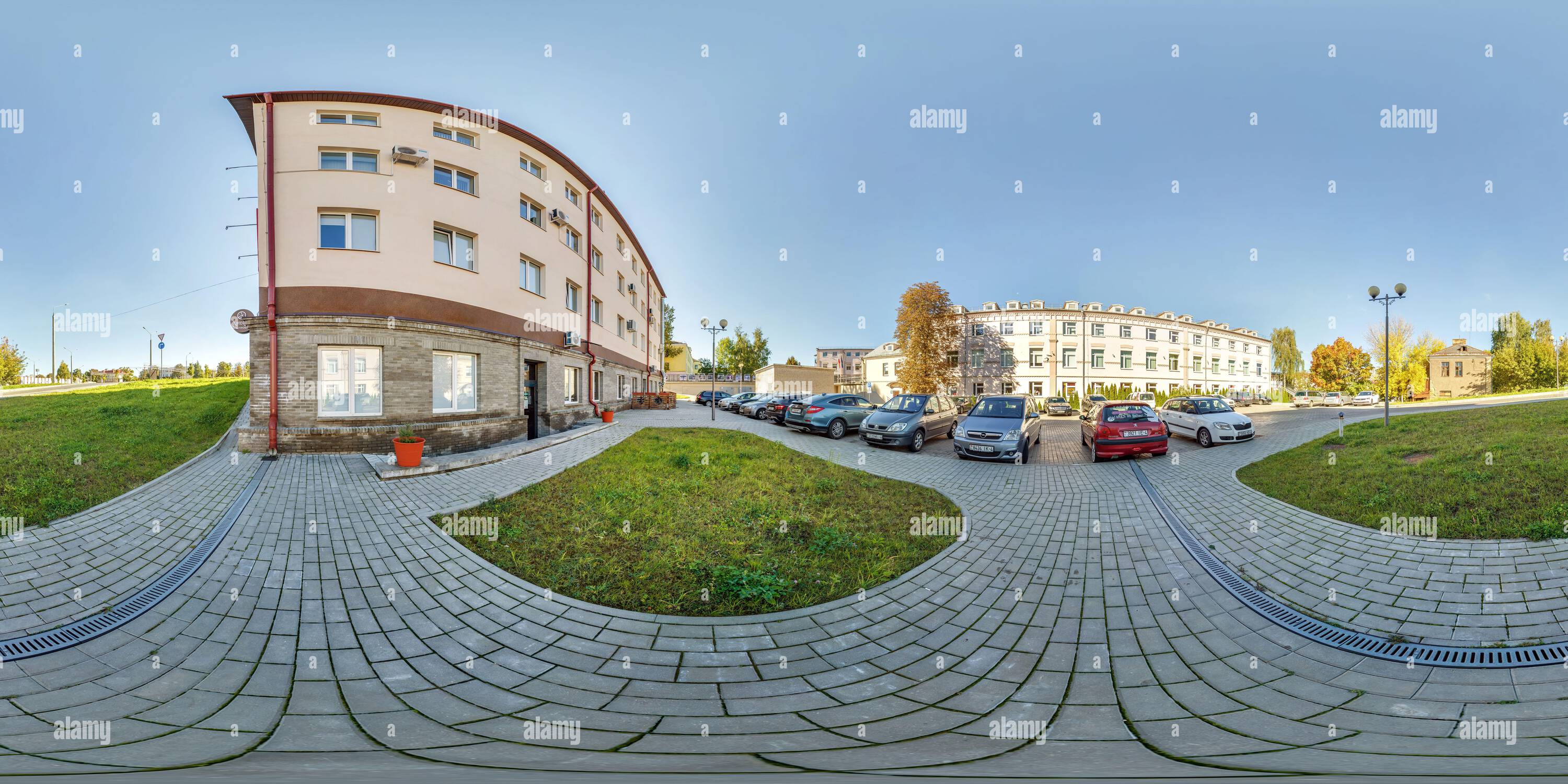360 degree panoramic view of GRODNO, BELARUS -  NOVEMBER 2021: full seamless hdri panorma 360 angle view on parking with cars near buildings provincial town at autumn sunny day in