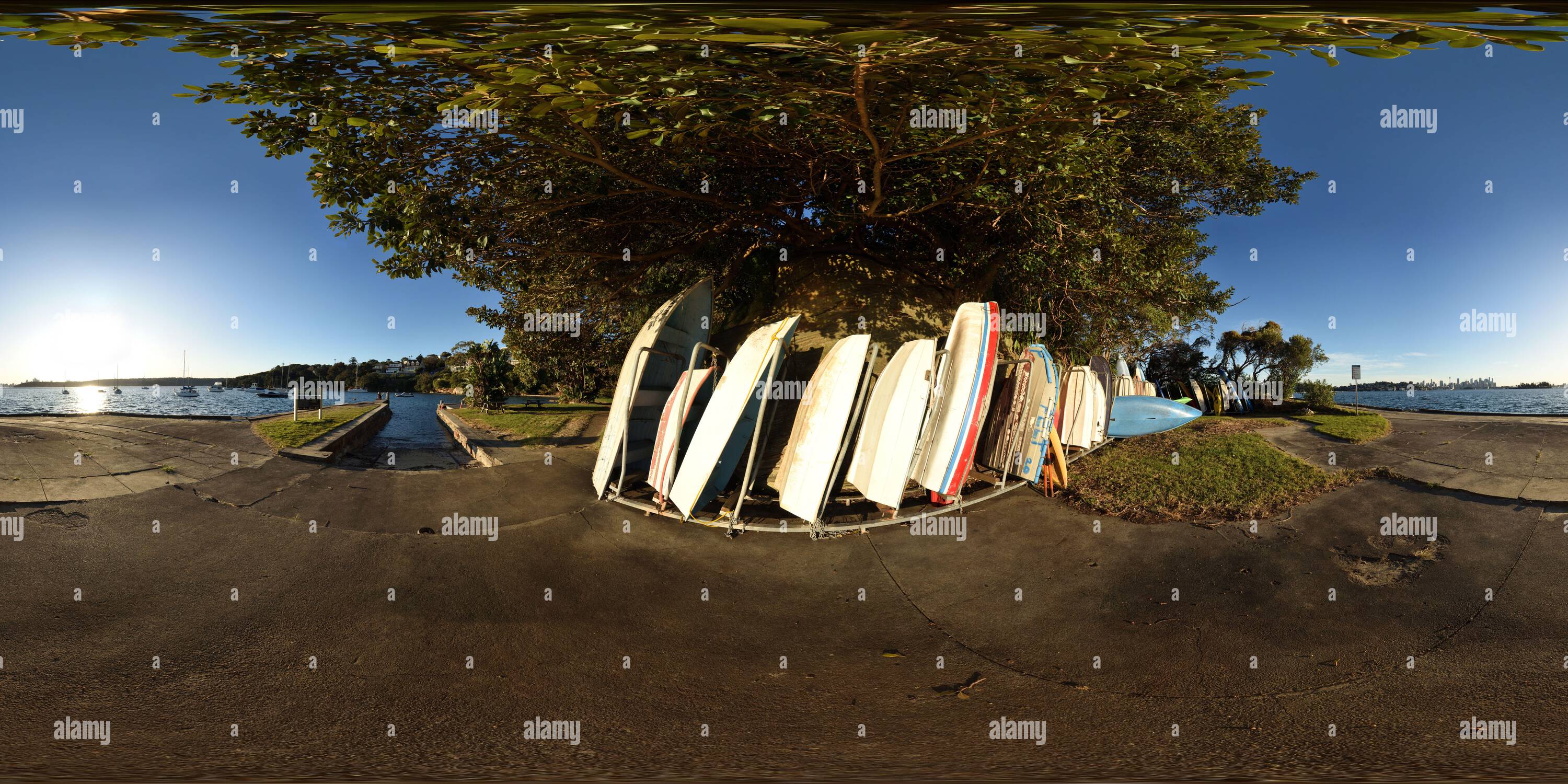 360 degree panoramic view of Rowboats stored in a rack Hermit Bay on in late afternoon sun Hermitage Foreshore Walk, Rose Bay, Sydney, Australia