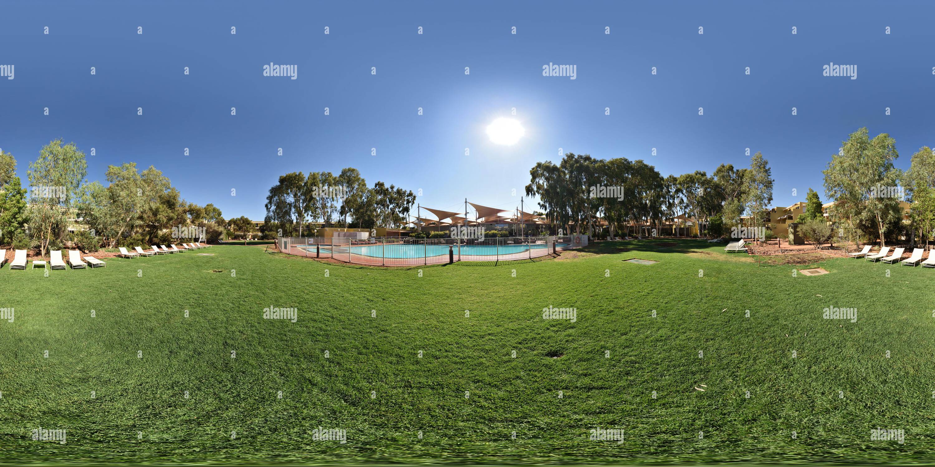 360 degree panoramic view of 360° Panorama of the grassed area with eucalyptus shade trees and fenced pool at Sails Resort, Yulara, Northern Territory, Australia