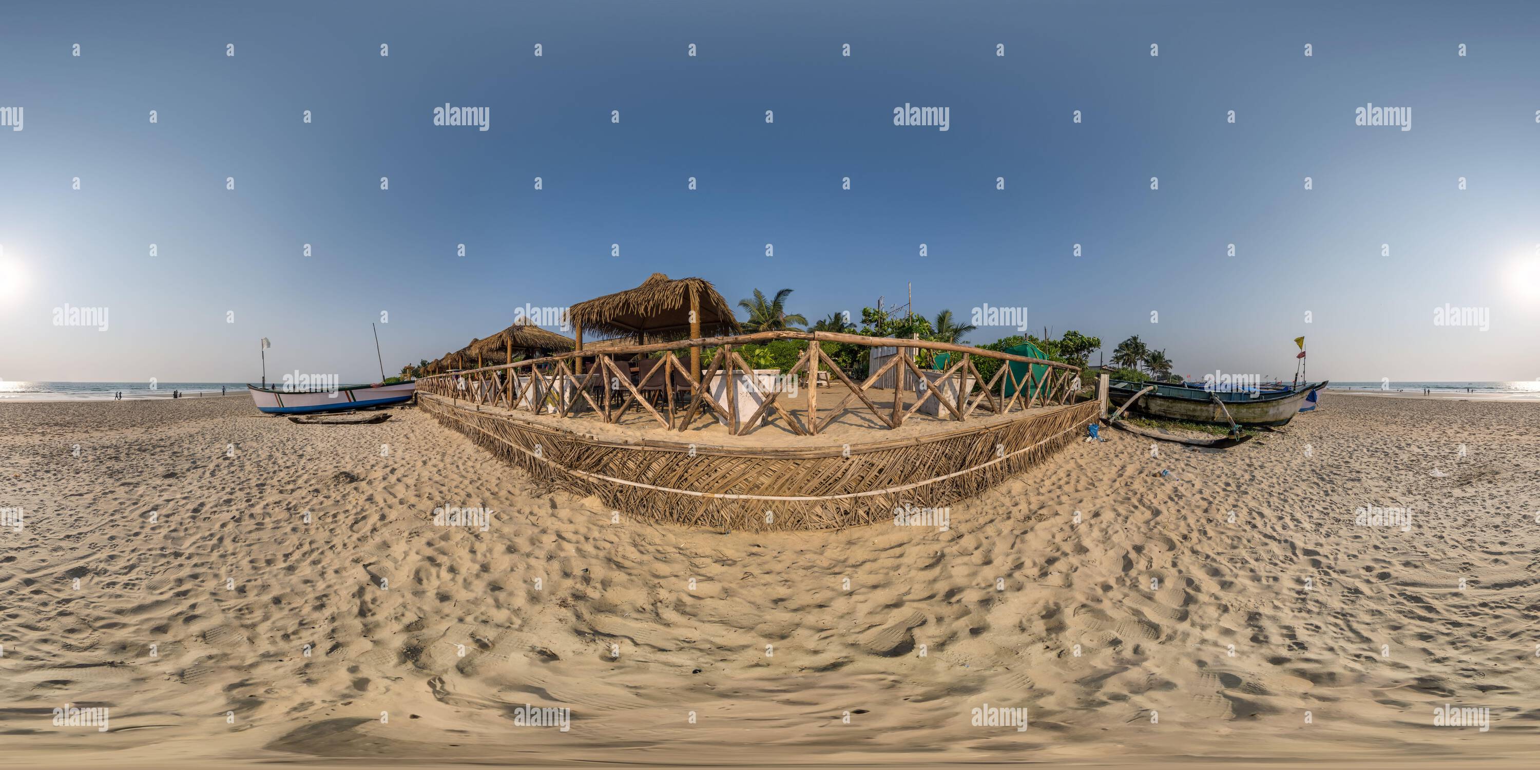 360 degree panoramic view of 360 hdri panorama with coconut trees on ocean coast near tropical shack or open air cafe on beach with fence in equirectangular spherical seamless pro