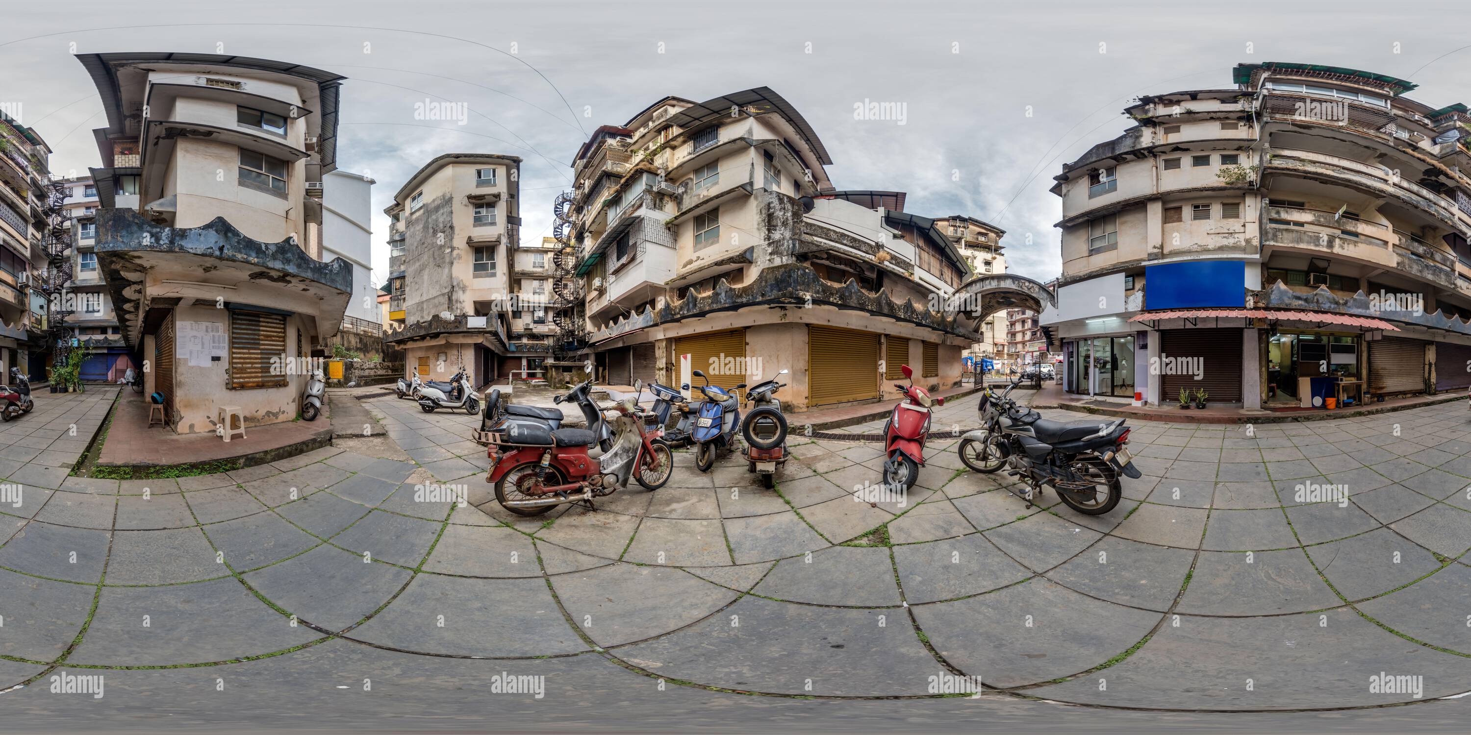 360 degree panoramic view of full seamless spherical hdr 360 panorama inside old houses in narrow courtyard or backyard of city bystreet with bike parking in an indian town in equ