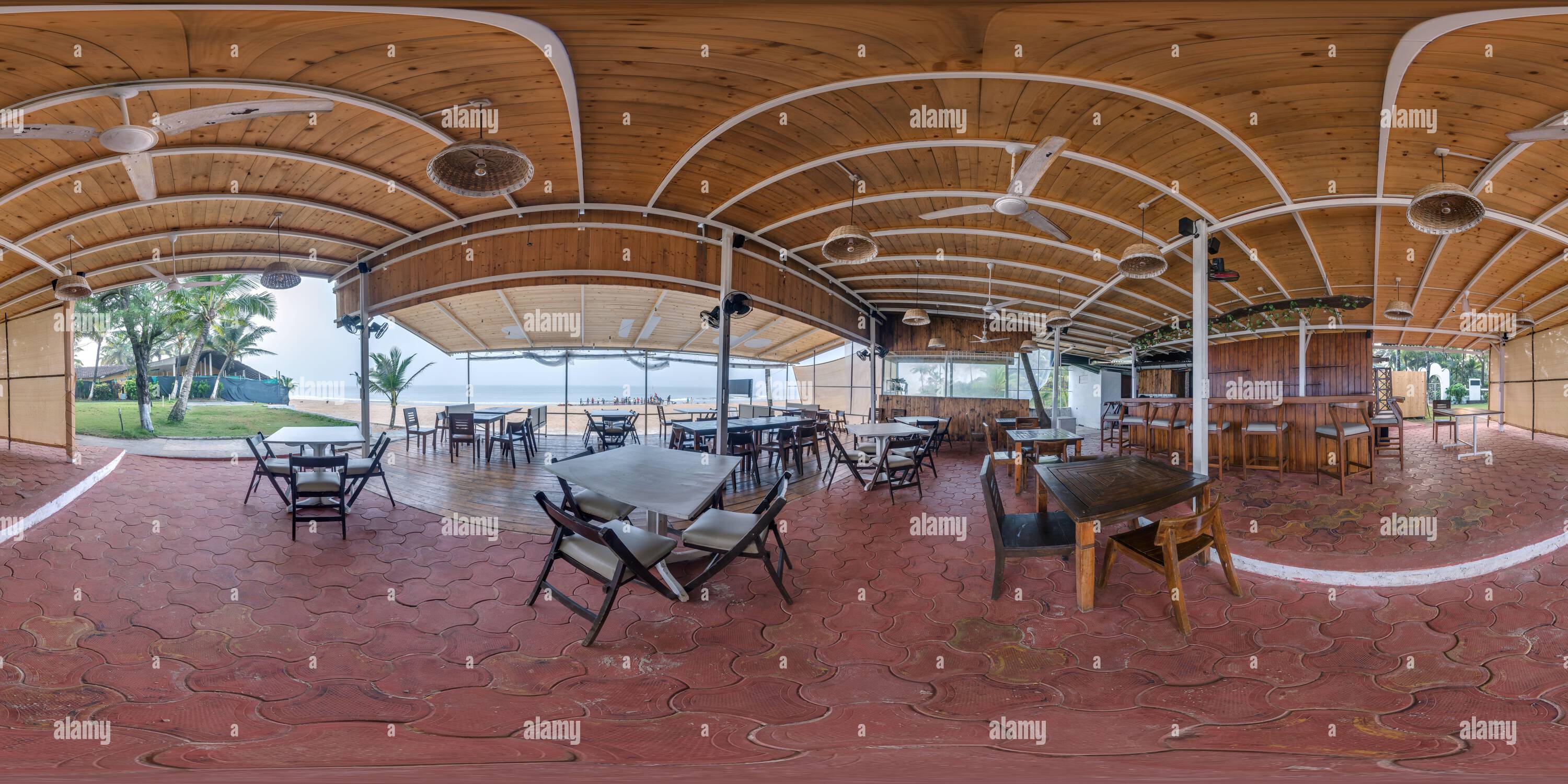 360 degree panoramic view of 360 hdri panorama inside tropical shack or open air cafe on beach with coconut trees on ocean coast in equirectangular spherical seamless projection,
