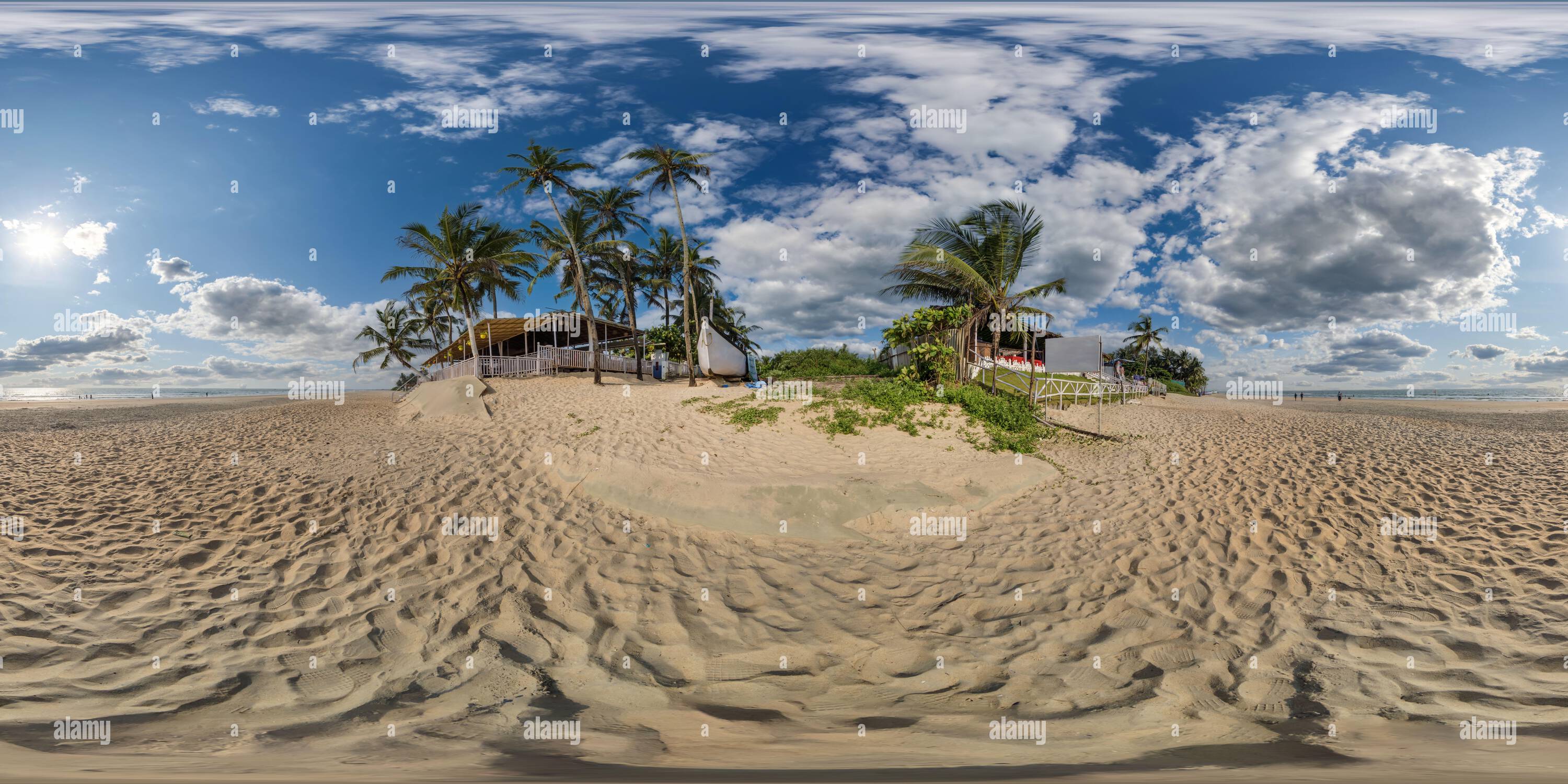 360 degree panoramic view of 360 hdri panorama with coconut trees on ocean coast near tropical shack or open air shack cafe on beach in equirectangular spherical seamless projecti