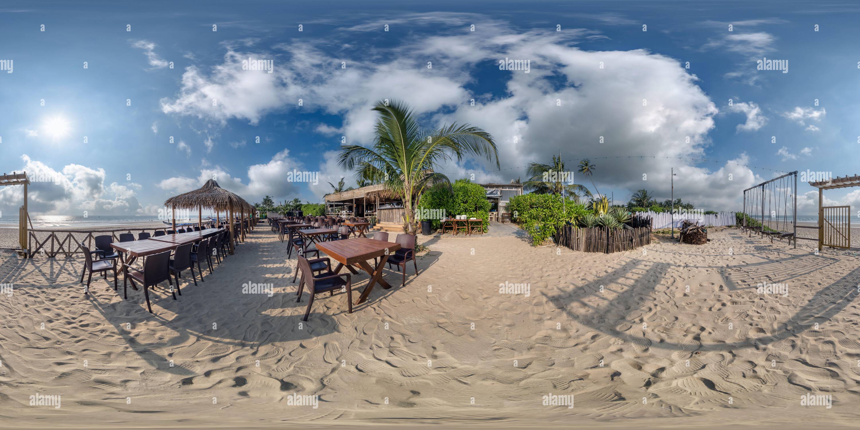 360 degree panoramic view of 360 hdri panorama with coconut trees on ocean coast near tropical shack or open cafe on beach with swing in equirectangular spherical seamless project