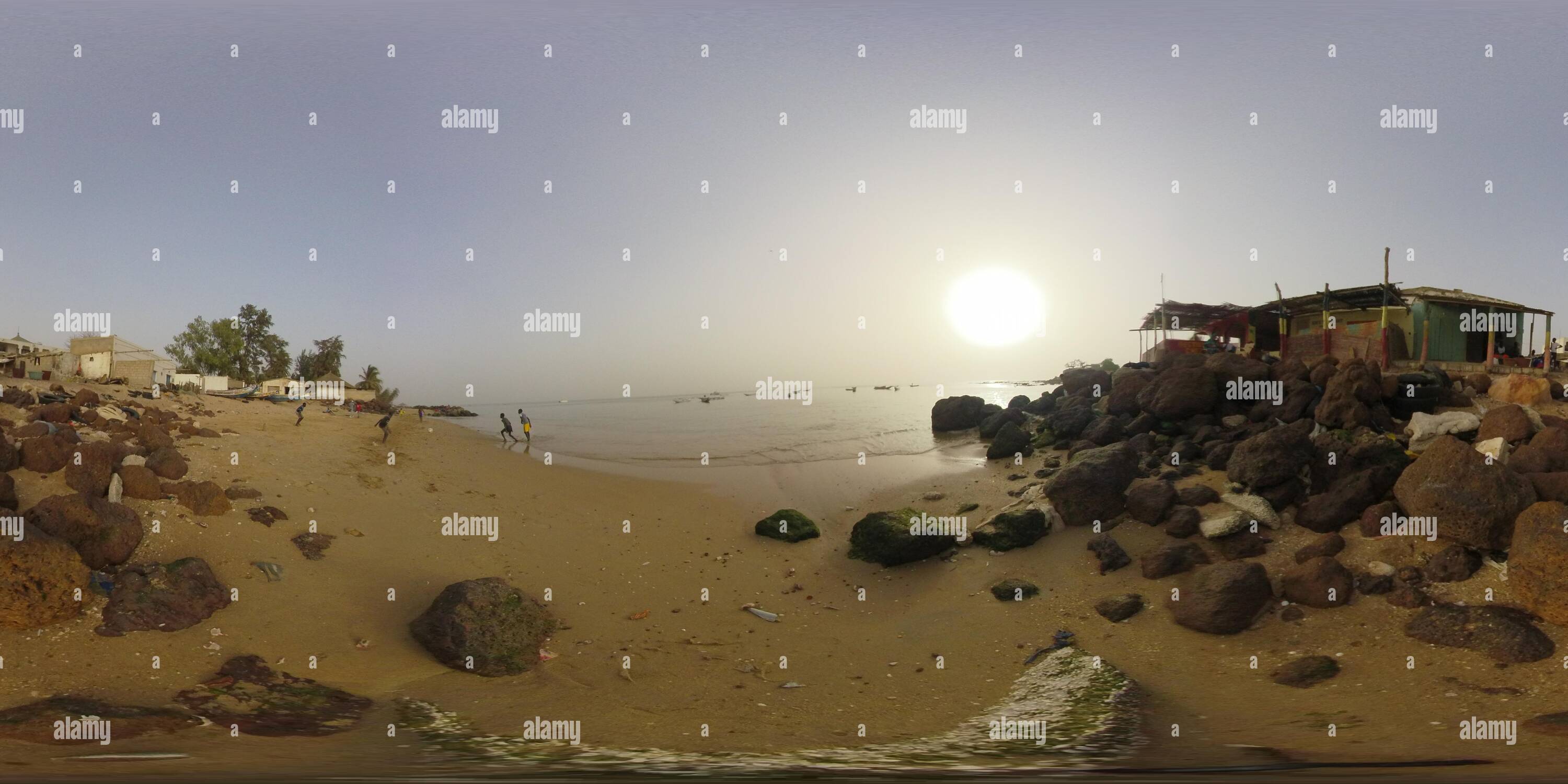 360 degree panoramic view of M´Bour, Senegal, 12th March 2019: 360 image of boys playing football by the sea