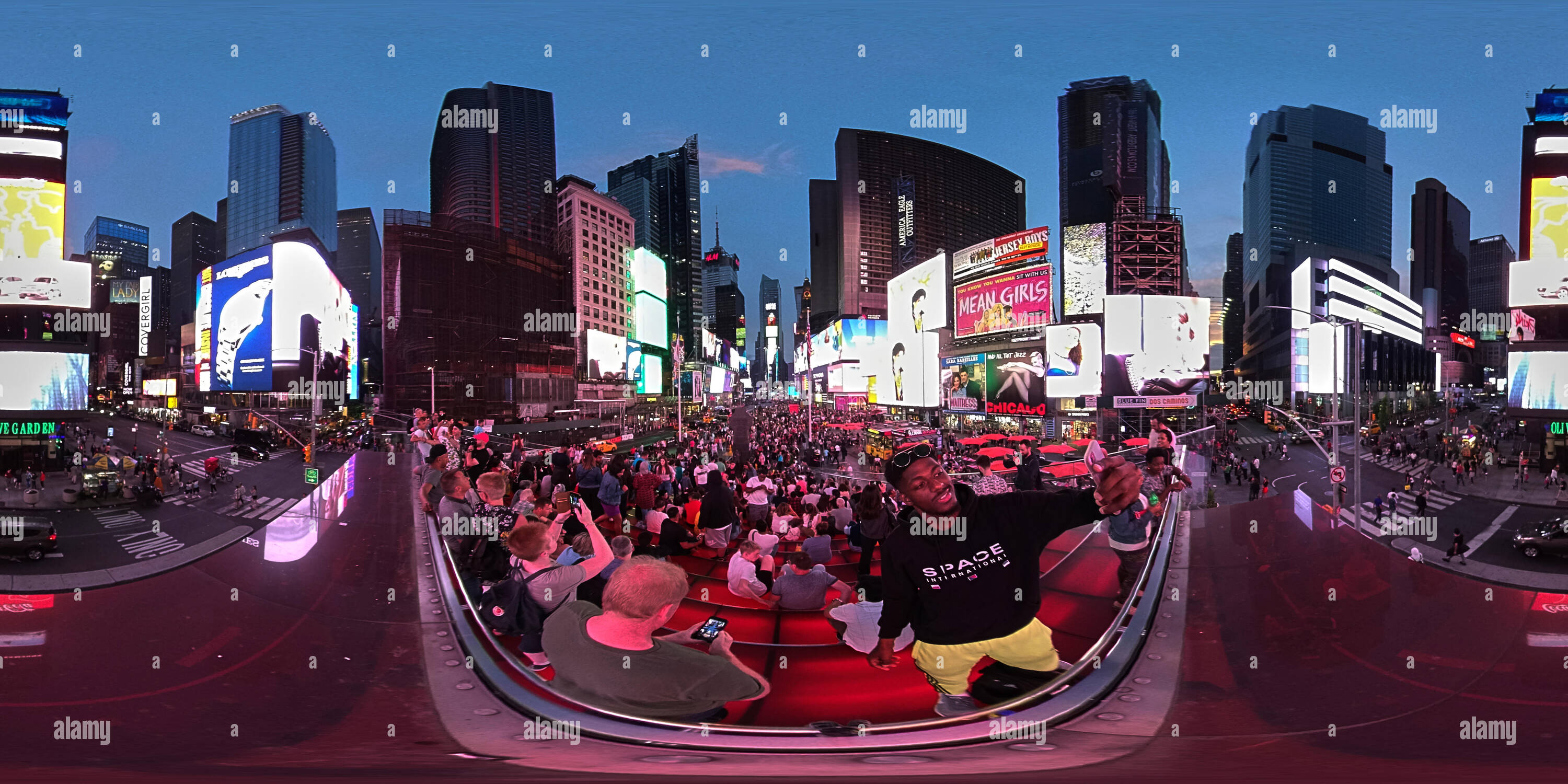 360 degree panoramic view of 360 panorama of Times Square New York at dusk with tourist taking selfies centre frame.